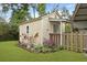 A quaint storage shed, with a beautiful flower garden, providing practical outdoor storage and enhancing garden aesthetics at 415 Whitebark Dr, Ladson, SC 29456