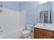 Bathroom with tub shower combination, wooden vanity, and mirror at 4209 Climbing Tree Ct, Charleston, SC 29414