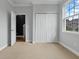 Bedroom with white trim and carpet, featuring a closet and open door at 4209 Climbing Tree Ct, Charleston, SC 29414