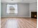 Bright living room showcasing hardwood floors and a cozy fireplace, enhanced by natural light at 4209 Climbing Tree Ct, Charleston, SC 29414