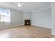 Bright living room featuring wood floors, a corner fireplace, and ample natural light from the window at 4209 Climbing Tree Ct, Charleston, SC 29414