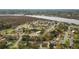 An aerial view of a community with tree-lined streets, homes, and river in background at 4343 Helene Dr, North Charleston, SC 29418