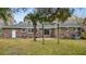 The backyard features a brick house, palm tree, green grass, and swing set frame at 4343 Helene Dr, North Charleston, SC 29418