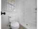 Compact, all-white bathroom features a new toilet and standing shower, creating a clean and efficient space at 4343 Helene Dr, North Charleston, SC 29418