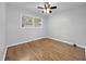 This bedroom features hardwood floors, neutral paint, a ceiling fan, and double windows for natural light at 4343 Helene Dr, North Charleston, SC 29418