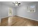 Bright bedroom with hardwood floors, ceiling fan, and two windows providing ample natural light at 4343 Helene Dr, North Charleston, SC 29418