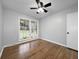 A bedroom with hardwood floors, neutral paint, a ceiling fan, and a bright window at 4343 Helene Dr, North Charleston, SC 29418
