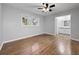 This bedroom has hardwood floors, natural light from the windows, and an attached bathroom at 4343 Helene Dr, North Charleston, SC 29418