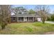 Traditional brick home with a well-maintained lawn, shuttered windows, and a welcoming front entrance at 4343 Helene Dr, North Charleston, SC 29418