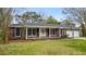 Charming single-story brick home with a well-manicured lawn and inviting front porch at 4343 Helene Dr, North Charleston, SC 29418