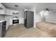 Updated kitchen with stainless steel appliances, white cabinets, and hardwood floors at 4343 Helene Dr, North Charleston, SC 29418