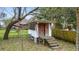 Rustic shed with a small porch, aged wood, and covered stairs in wooded backyard at 4343 Helene Dr, North Charleston, SC 29418