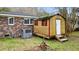 Colorful shed in backyard next to brick house and AC unit. A perfect workshop space at 4343 Helene Dr, North Charleston, SC 29418
