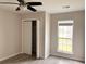 This bedroom features a ceiling fan, a window, and an open closet with bi-fold doors at 4414 Rice Mill Dr, North Charleston, SC 29420