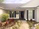 Attractive home entrance with lush landscaping, flowering plants, and a welcoming front door at 4414 Rice Mill Dr, North Charleston, SC 29420