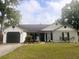 Charming single-story home featuring a well-manicured lawn and an attached garage at 4414 Rice Mill Dr, North Charleston, SC 29420