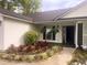 Inviting entrance with manicured flowerbeds and hanging ferns, creating a warm welcome at 4414 Rice Mill Dr, North Charleston, SC 29420