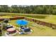 Expansive backyard featuring a fenced yard, a hot tub, and outdoor furniture under a blue umbrella by the pond at 477 Spanish Wells Rd, Summerville, SC 29486