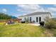 Backyard with an outdoor seating area under a blue umbrella, a hot tub, and a grilling area at 477 Spanish Wells Rd, Summerville, SC 29486