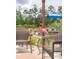 Charming backyard with patio seating, flamingo decor, plants, and a blue umbrella for a relaxing outdoor retreat at 477 Spanish Wells Rd, Summerville, SC 29486