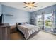 Cozy bedroom with blue walls, carpeted floor, and a comfortable bed with gray bedding at 477 Spanish Wells Rd, Summerville, SC 29486