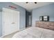 Light blue bedroom featuring a dresser, television, and double closet doors with plush carpet flooring at 477 Spanish Wells Rd, Summerville, SC 29486