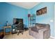 Blue bedroom featuring a TV, chair and window with curtains at 477 Spanish Wells Rd, Summerville, SC 29486