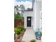 A black front door with seasonal decor and a decorative door wreath, surrounded by landscaping at 477 Spanish Wells Rd, Summerville, SC 29486