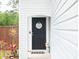 A black front door features a decorative wreath and is framed by landscaping at 477 Spanish Wells Rd, Summerville, SC 29486