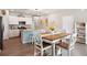 Open kitchen and dining area with stainless appliances, stylish decor, and wood grain flooring at 477 Spanish Wells Rd, Summerville, SC 29486