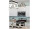Kitchen showcasing stainless appliances, granite countertops, and stylish decor on the white cabinets at 477 Spanish Wells Rd, Summerville, SC 29486