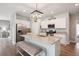 Stylish kitchen featuring granite countertops, stainless appliances and gray bench seat at island at 477 Spanish Wells Rd, Summerville, SC 29486