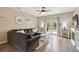 Cozy living room features a comfortable gray sectional sofa, stylish ceiling fan, and French doors to the backyard at 477 Spanish Wells Rd, Summerville, SC 29486