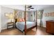 Spacious bedroom featuring a four-poster bed, ceiling fan, and charming decor for a cozy retreat at 5037 Alpha St, North Charleston, SC 29405