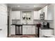 Bright kitchen with white cabinetry, modern stainless steel appliances, and sleek countertops at 5037 Alpha St, North Charleston, SC 29405