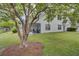 Charming home with a screened patio overlooking a lush green yard and pond at 5223 Fernland Way, Charleston, SC 29420