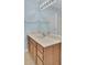 Bathroom featuring a wood vanity, light blue walls, a large mirror, and tan flooring at 5223 Fernland Way, Charleston, SC 29420