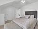 Bright bedroom features a soft bench, patterned bed comforter, and side table at 5223 Fernland Way, Charleston, SC 29420