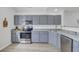 Corner kitchen view showing gray cabinets, stainless steel appliances, and granite countertops at 5223 Fernland Way, Charleston, SC 29420