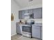 Updated kitchen with gray cabinets, granite countertops, and stainless steel oven at 5223 Fernland Way, Charleston, SC 29420