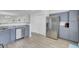 Modern kitchen with stainless steel appliances, gray cabinets, and an open layout at 5223 Fernland Way, Charleston, SC 29420
