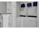 Convenient laundry area with washer, dryer, shelving, and storage at 5223 Fernland Way, Charleston, SC 29420
