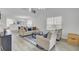 Open-concept living room with high ceilings, hardwood floors, and plenty of natural light from large windows at 5223 Fernland Way, Charleston, SC 29420