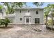 The back exterior of the home with a stone patio, bay window, and sliding glass door at 543 Castle Hall Rd, Mount Pleasant, SC 29464