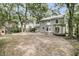 Wide shot of backyard with mature trees, playground, pergola, and house exterior at 543 Castle Hall Rd, Mount Pleasant, SC 29464