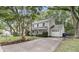 Charming two-story home with a well-manicured front yard, mature trees, and a spacious driveway at 543 Castle Hall Rd, Mount Pleasant, SC 29464