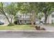 Charming home with lush landscaping, mature trees, and a welcoming front porch at 543 Castle Hall Rd, Mount Pleasant, SC 29464