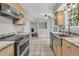 Bright kitchen with a stainless steel farmhouse sink, granite countertops, and stainless steel appliances at 543 Castle Hall Rd, Mount Pleasant, SC 29464