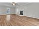 Bright living room features wood floors, a ceiling fan, a fireplace, and a sunlit window at 543 Castle Hall Rd, Mount Pleasant, SC 29464