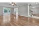 Spacious living room with wood floors, stairs to the upper level, and sliding glass doors to the backyard at 543 Castle Hall Rd, Mount Pleasant, SC 29464